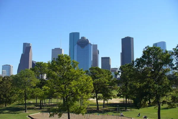 The downtown Houston skyline over the trees of Eleanor Tinsley Park